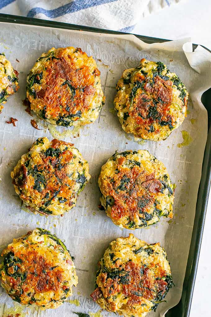 Close up of browned baked cheesy spinach bacon cakes fresh from the oven