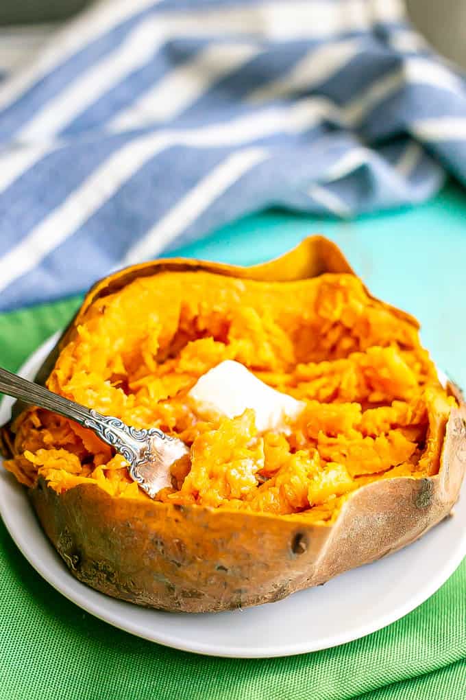 A forkful of tender sweet potato being scooped out