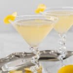 Two lemon drop martinis on a silver tray with a text box on top