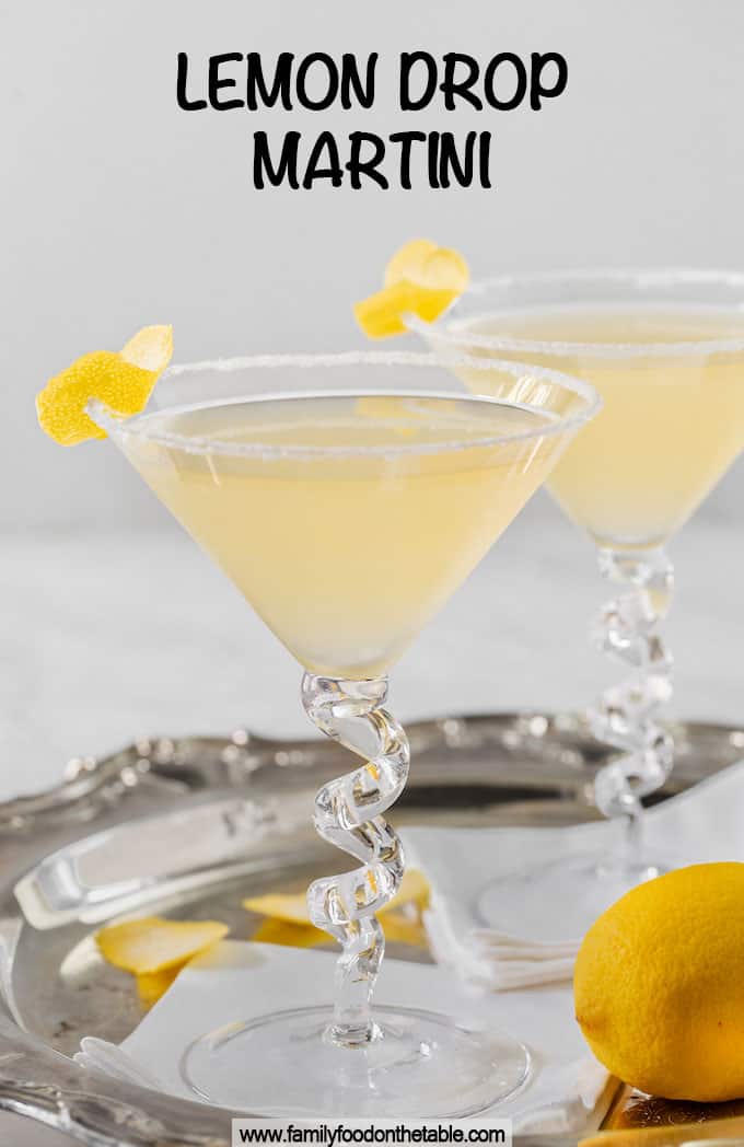 Two lemon drop martinis on a silver tray with a text box on top