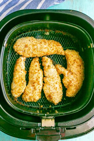Crunchy chicken tenders in an Air Fryer tray after being cooked