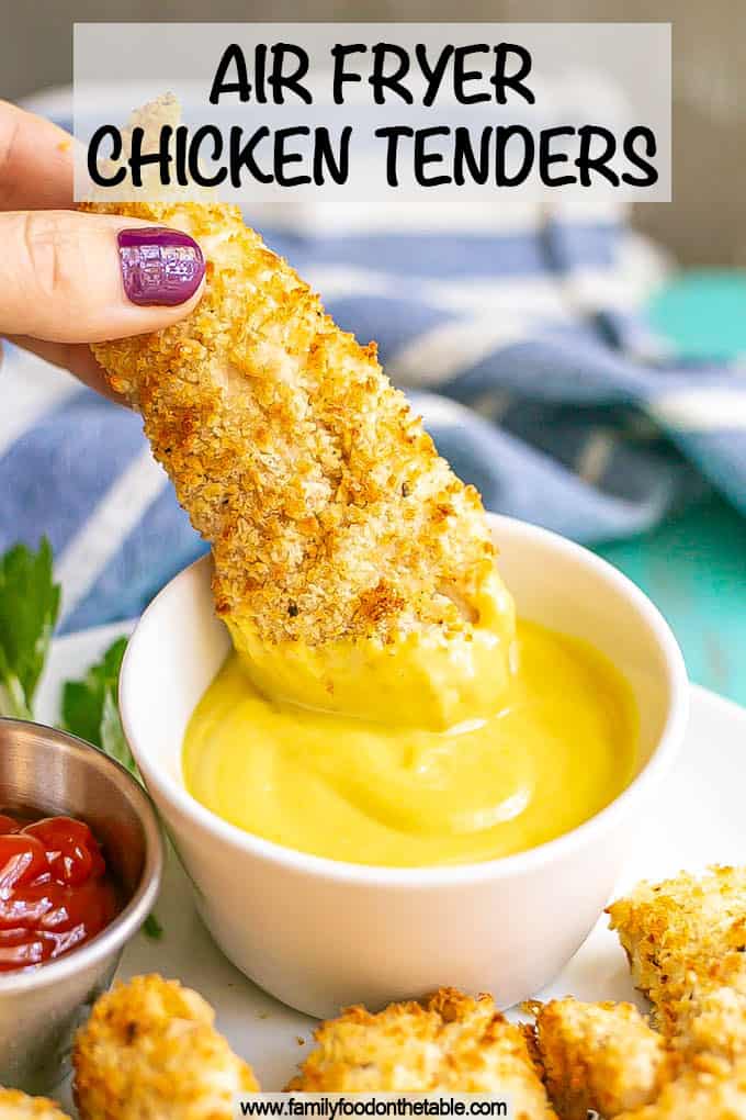 A crispy chicken tender being dipped in a small white bowl of honey mustard with a text overlay on the photo