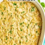 A creamy baked artichoke dip in a white casserole dish with a text overlay on top
