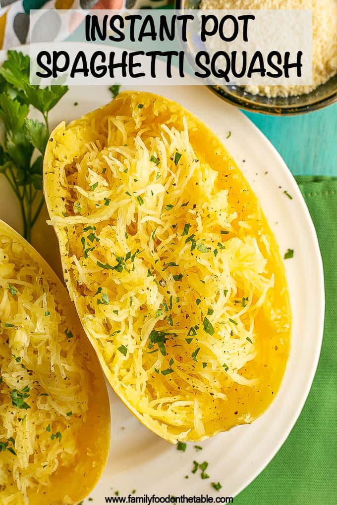 A halved and pulled cooked spaghetti squash with parsley and a bowl of Parmesan cheese nearby with a text overlay on the photo
