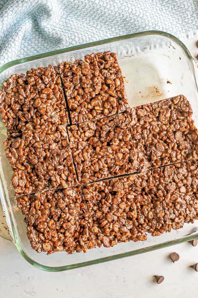 Chocolate rice Krispies cut into large squares in a glass pan after setting up