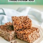 A stack of chocolate rice krispy treats on a white plate with chocolate chips scattered nearby and a text overlay on the photo
