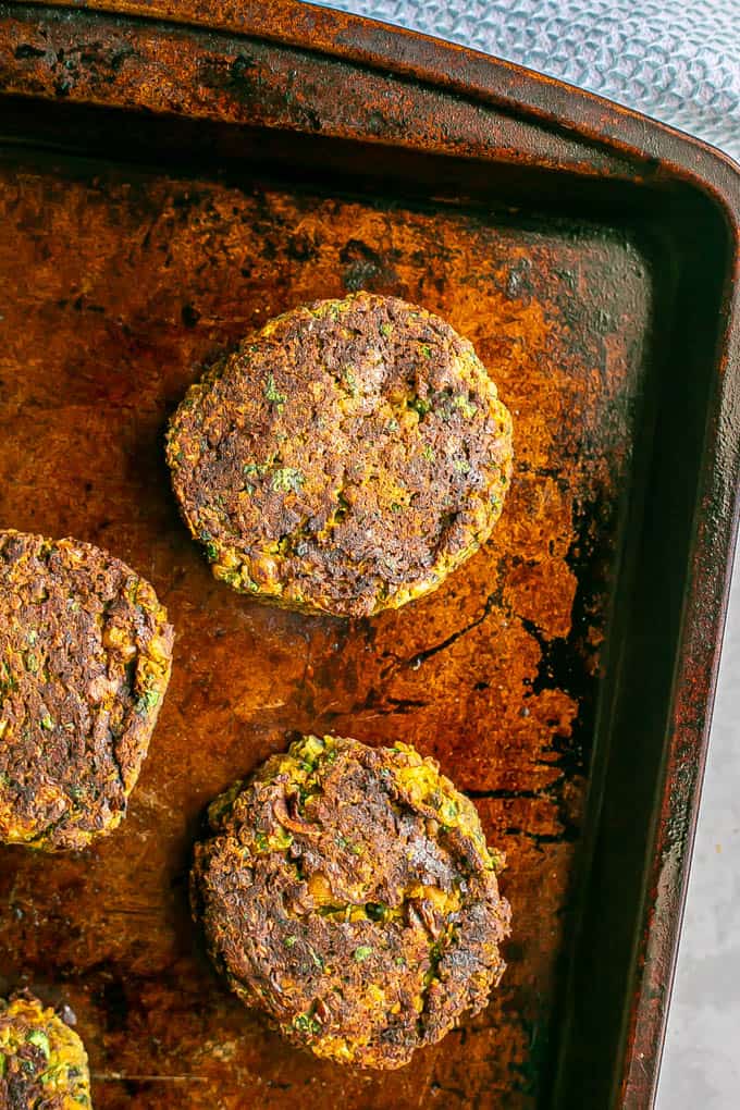 Browned baked falafel patties on a baking sheet