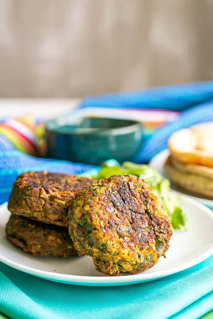 A trio of baked falafel patties on a white plate