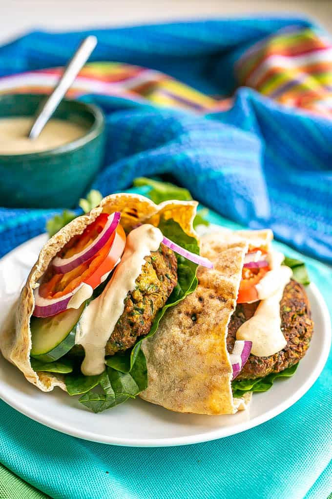 Baked falafel stuffed into pita halves along with some fresh veggies and topped with a tahini sauce