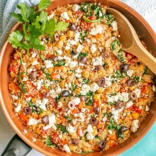 A Mediterranean veggie skillet with chickpeas and quinoa with feta and parsley on top