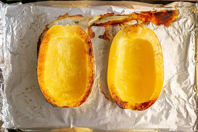 Two spaghetti squash halves after roasting in the oven