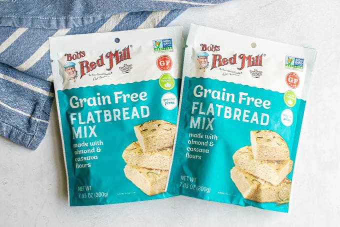 Two pouches of Bob's Red Mill flatbread mix on a counter