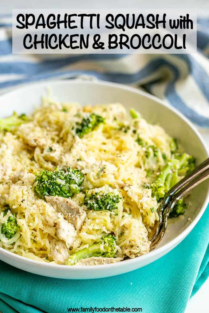 A white dinner bowl filled with spaghetti squash mixed with chicken and broccoli and topped with Parmesan cheese with a text overlay on the photo