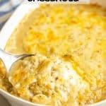 A metal spoon scooping up some chicken and rice casserole from a large white baking dish with a text overlay on the photo