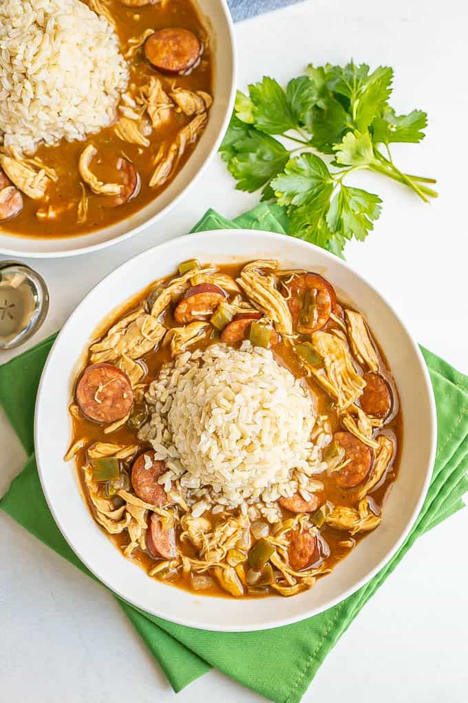 Chicken gumbo served in wide, low bowls with a pile of rice in the middle of the bowls