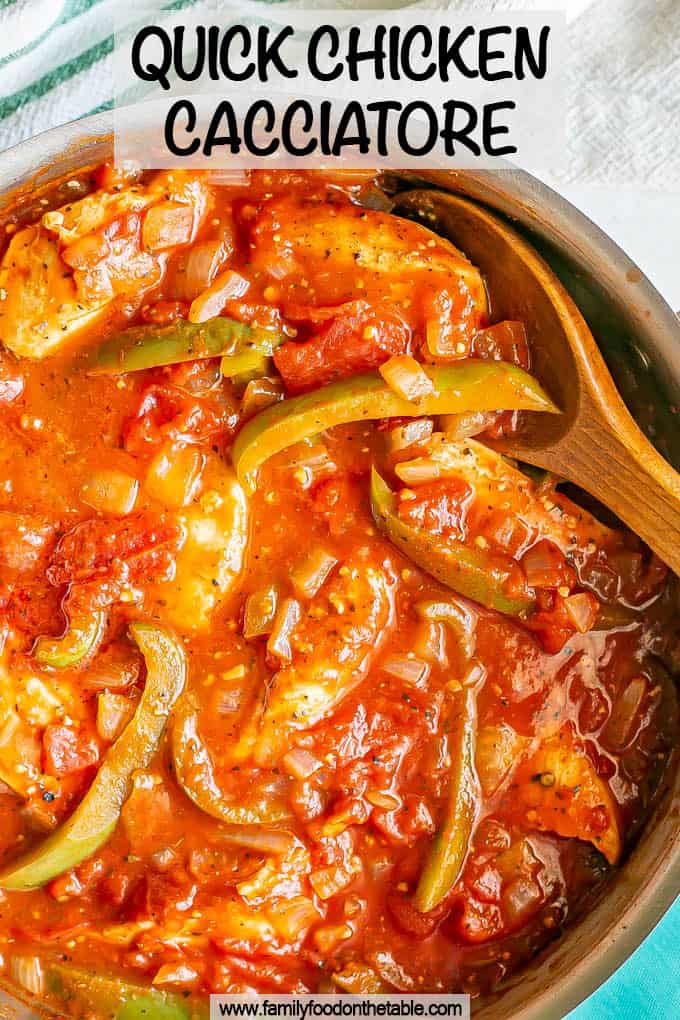 A large skillet filled with chicken strips, peppers and tomato sauce with a spoon resting in it and a text overlay on top