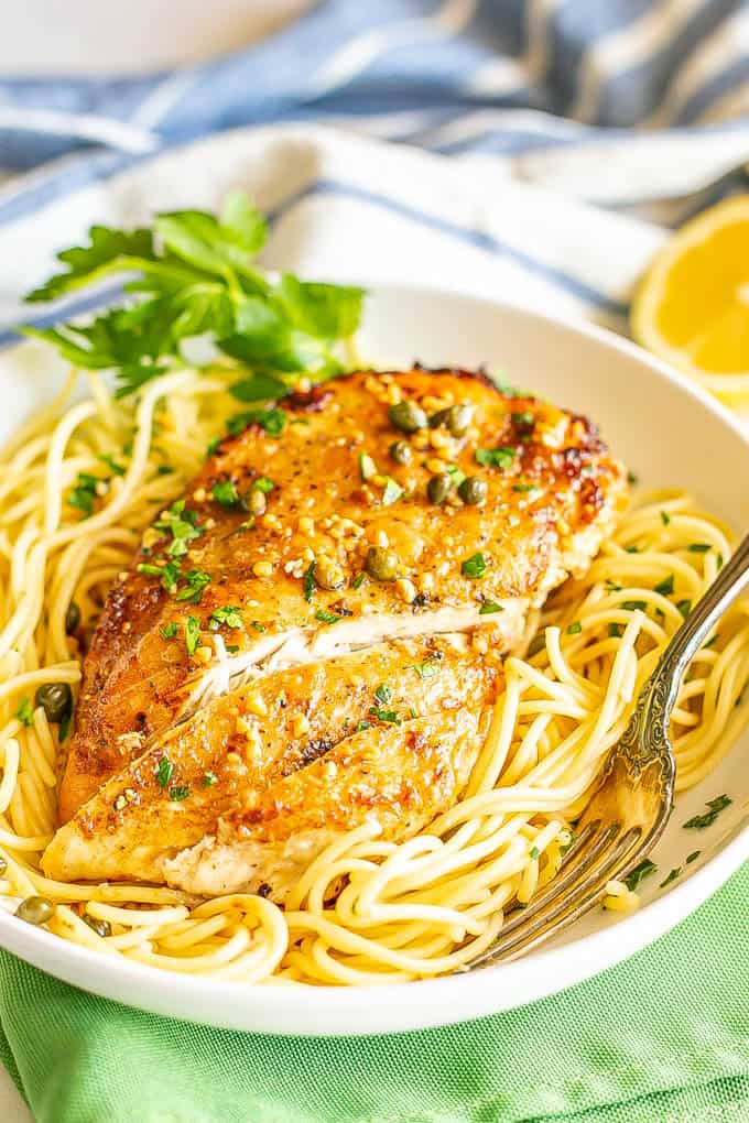 A thin, browned, sliced chicken breast served over spaghetti noodles with a sauce of capers, lemon and white wine