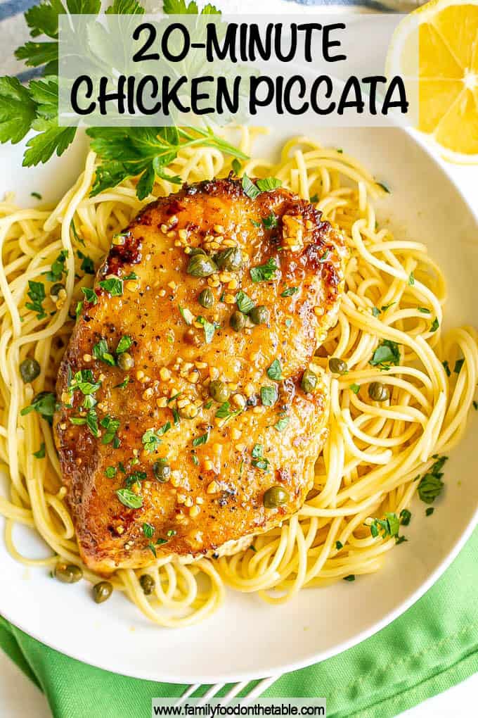 A thin, browned chicken breast served over spaghetti noodles with a sauce of capers, lemon and white wine with a text overlay on the photo