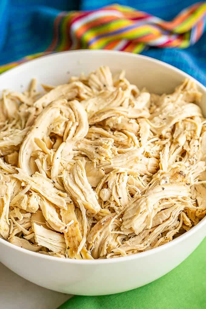 Shredded cooked chicken served in a large white bowl