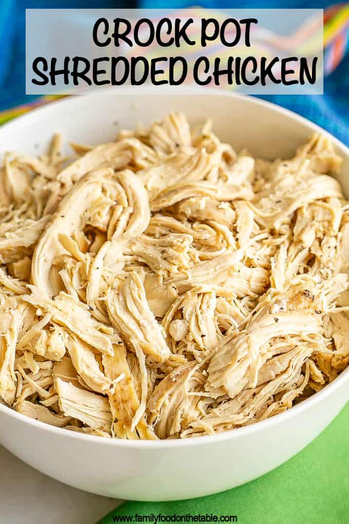 Shredded cooked chicken served in a large white bowl with a text overlay on the photo