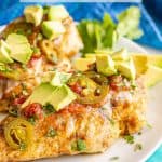 Grilled chicken breasts served on a white plate and topped with cheese, salsa, avocado, jalapeƱos and cilantro with a text overlay on the photo