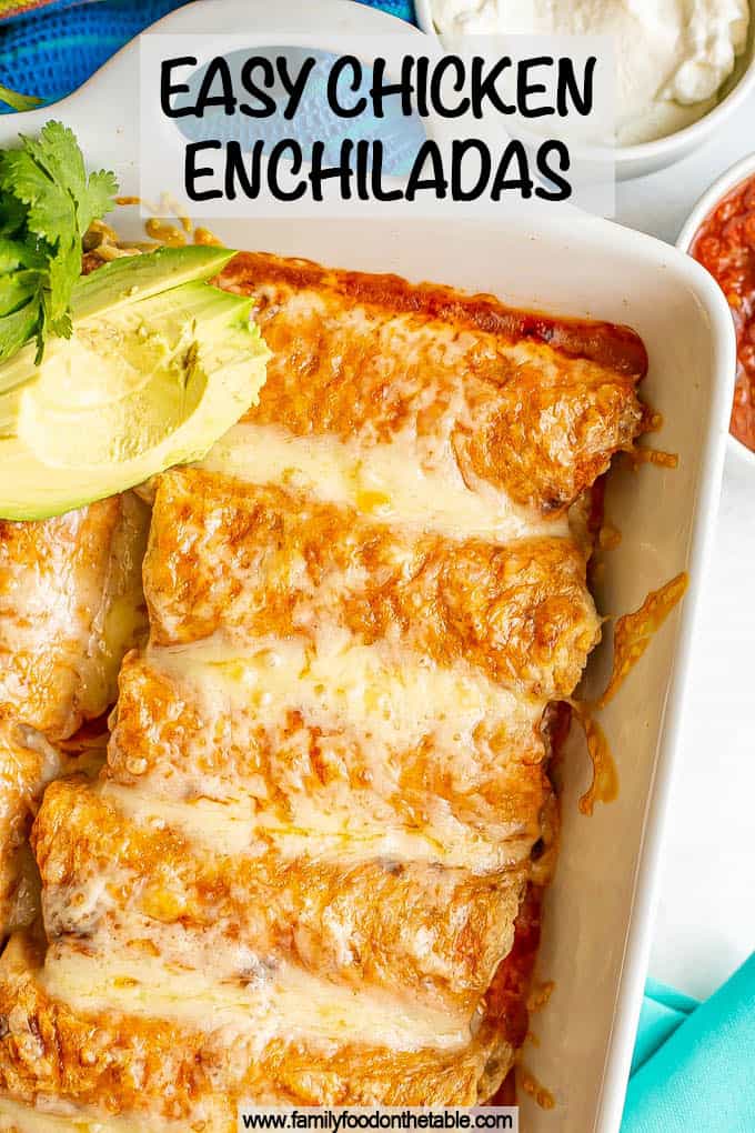 A white pan filled with cheesy chicken enchiladas with a text overlay on the photo