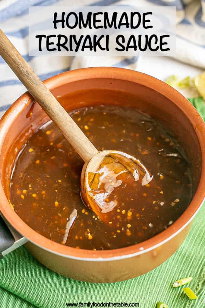 A small sauce pan with a wooden spoon resting in some homemade teriyaki sauce and a text overlay on the photo