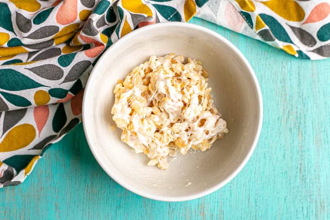 Overhead shot of a marshmallow sticky microwave Rice Krispie treat in a bowl after being mixed together