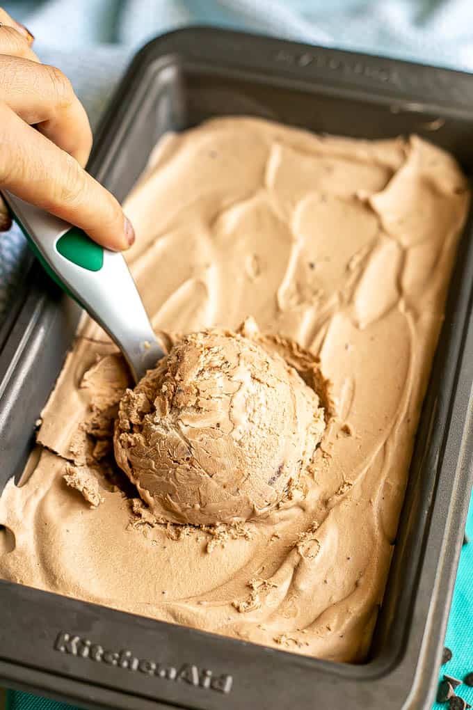 A scoop of homemade no churn chocolate ice cream being taken from a small pan