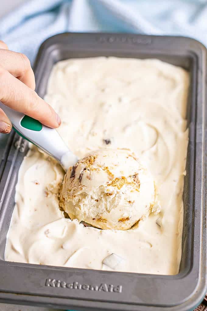 Homemade s'mores ice cream being scooped out from a small pan