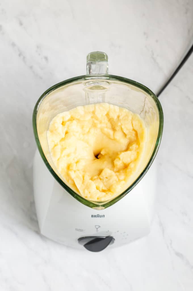 Overhead shot of a blender with an orange slushy mixture