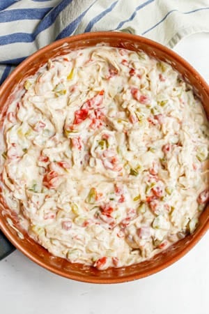 A creamy chicken and tomato mixture in a copper skillet