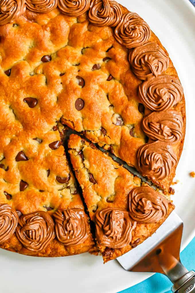 A slice being taken out of a chocolate chip cookie cake