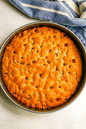 A cookie cake in a springform pan after baking in the oven