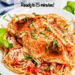 A broiled and browned chicken Parm cutlet served over spaghetti with basil sprinkled on top and a text overlay on the photo