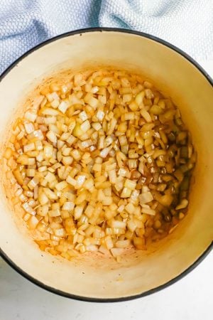 Onions sautéed in bacon grease in a large pot