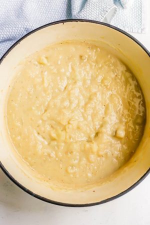 Partially pureed potatoes in a creamy mixture in a large pot