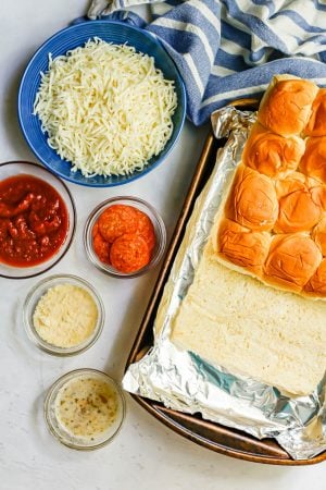 Ingredients to make pepperoni pizza sliders laid out on a counter