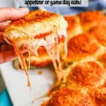 A hand holding up a cheesy pepperoni pizza slider from a plate of sliders with a text overlay on the photo