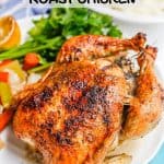 A browned and crispy whole roasted chicken on a platter with roasted veggies and fresh parsley with a text overlay on the photo