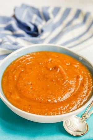 A blue and white bowl filled with smooth, blended homemade applesauce