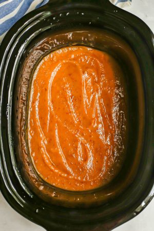 Pureed, smooth applesauce in a slow cooker insert