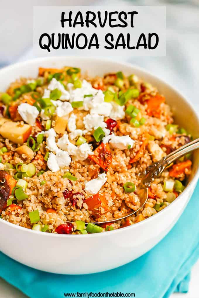 A large white bowl with a grain and veggie mix of quinoa, sweet potatoes, apples, feta cheese and green onions with a spoon resting in the bowl and a text box on the photo