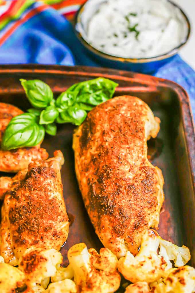 Close up of spiced roasted chicken on a sheet pan