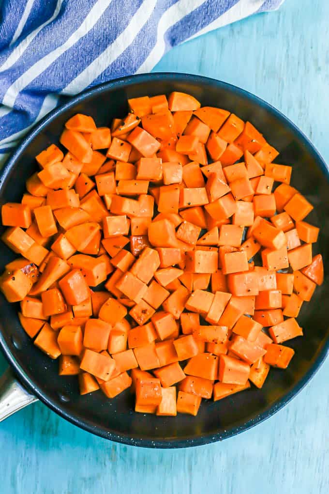 Cooked, cubed sweet potatoes in a large skillet