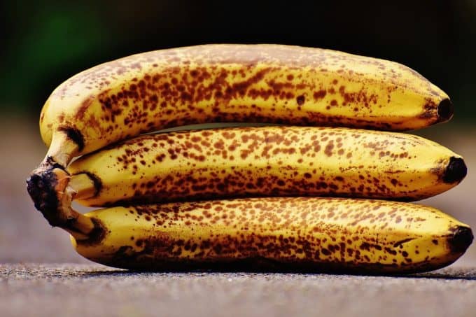 A trio of ripe bananas lying on their side