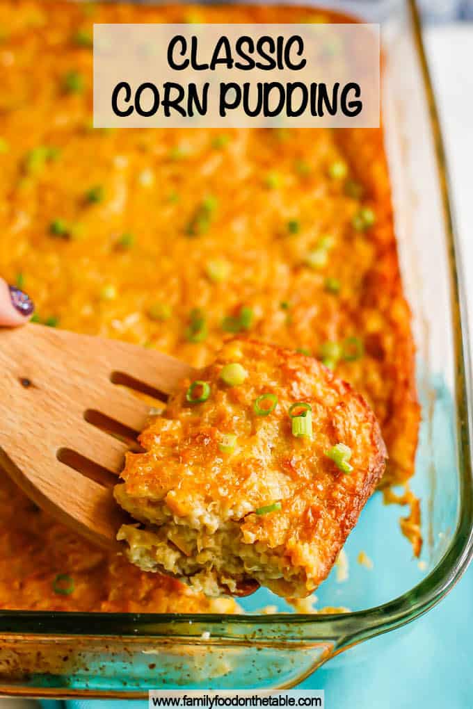 A square piece of corn pudding lifted up on a wooden spatula from the casserole dish with a text overlay on the photo