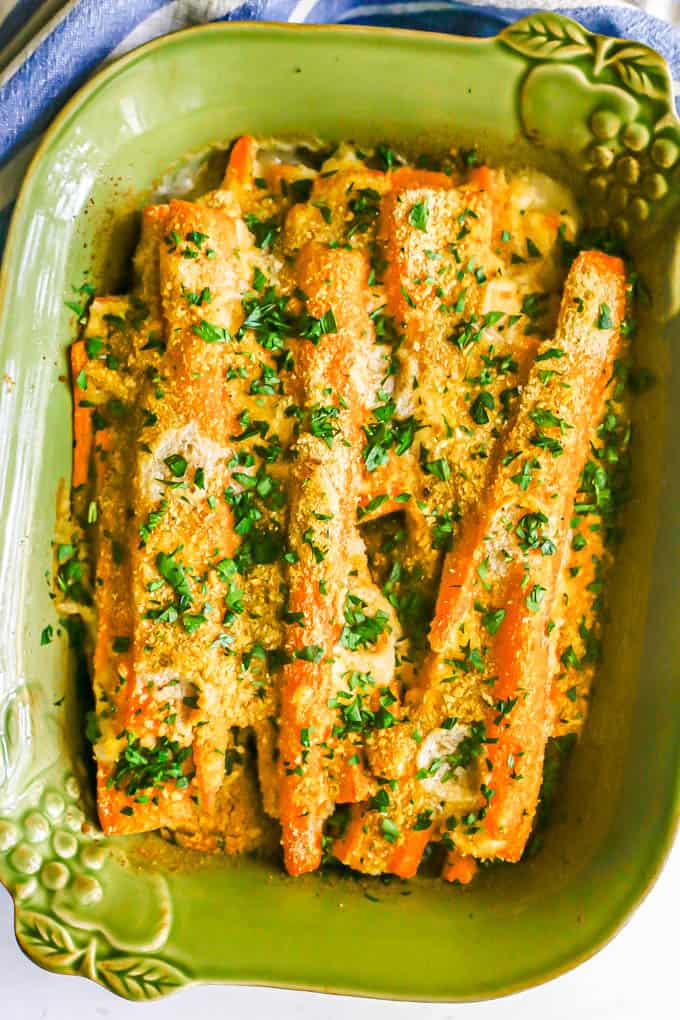 Baked carrots with a creamy sauce and toasted breadcrumbs for a topping with fresh chopped parsley sprinkled over the dish