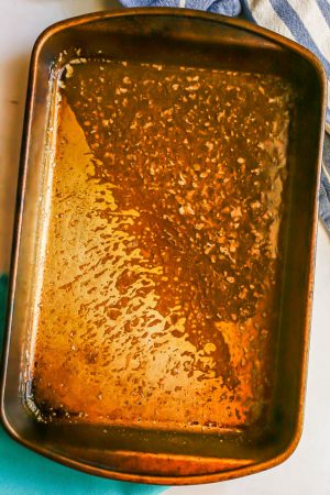 An old baking pan with a melted butter and seasoning mixture