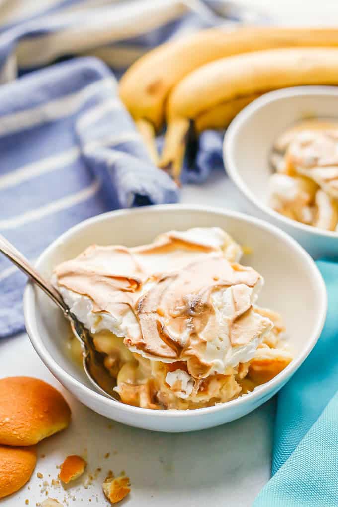 A small serving dish of banana pudding with a spoon tucked into the side